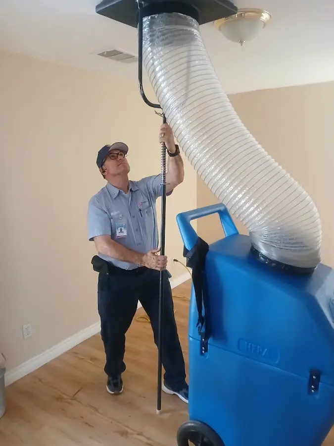 Furnace Tune-Up technician using HEPA equipment in Cuero